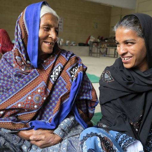 Two women laughing together, Pakistan
