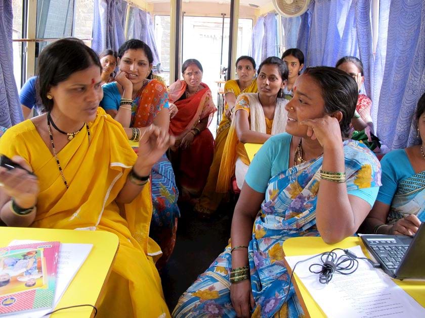 women learning on a bus